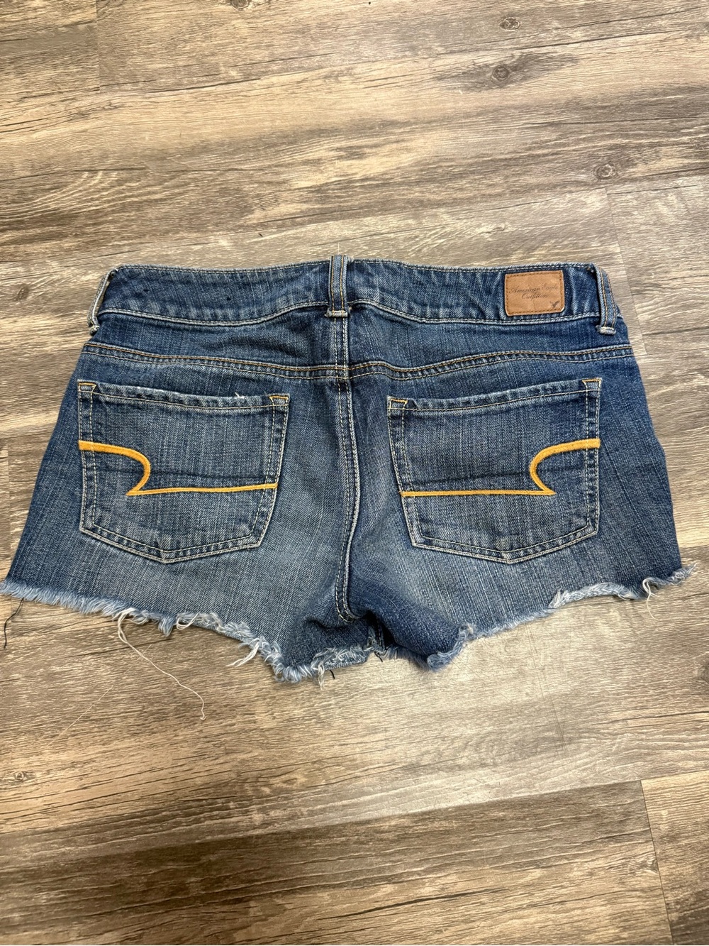 American Eagle Outfitters Blue Denim Cutoff Shorts with Yellow Pocket Stitch